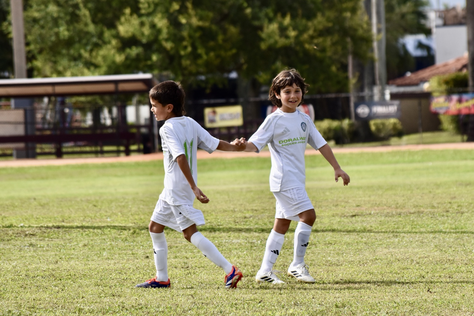 Young Doral West teammates celebrating and supporting each other
