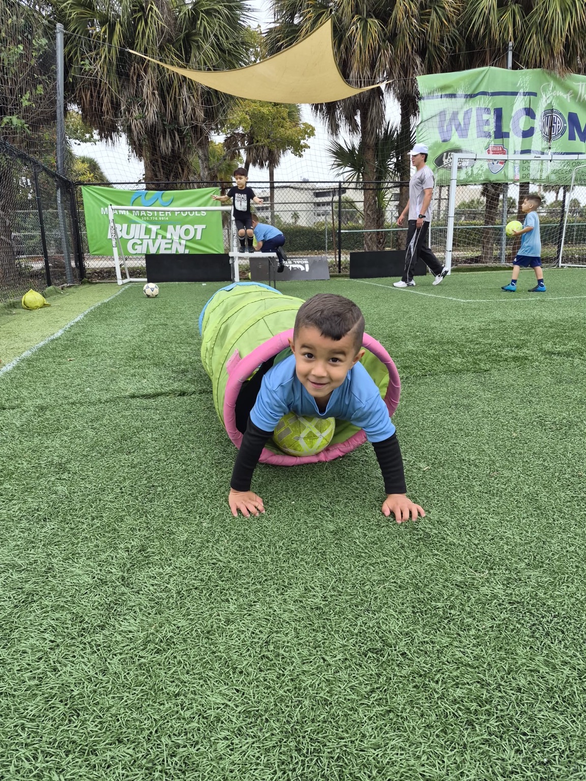 PLAY+ REC child completing a fun soccer obstacle